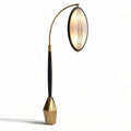 Arched floor lamp with oval shade and geometric base in gold and black finish