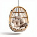 Hanging rattan chair with beige cushions for indoor and outdoor use